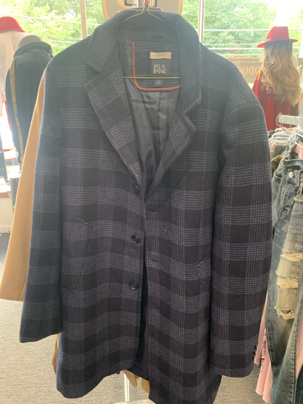 Dark plaid coat with notched lapels and a button front